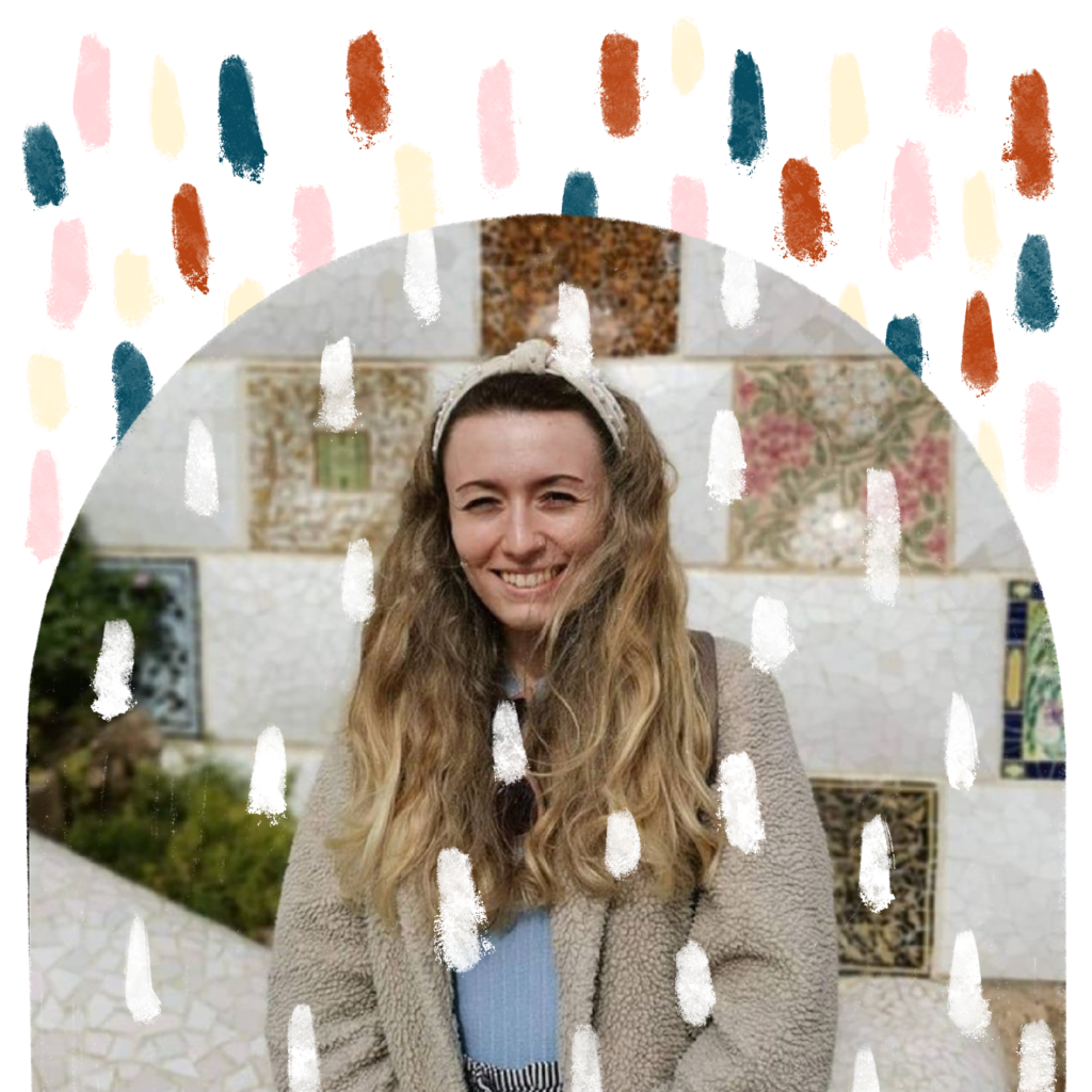 A Picture of the founder of A Little Bit of Hope, Hope , in Barcelona's Parc Guell, in front of the mosaic tiled wall. The picture is decorated with ALBoH's signature rust, pink, navy and pale yellow dashes.