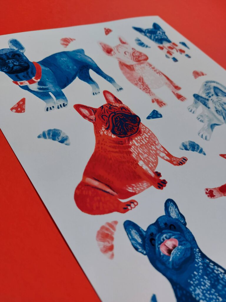 Illustrated French Bulldogs in a red and blue colour palettes with croissants in the background.