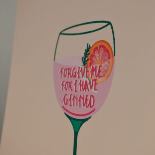 A peach or aubergine coloured print with a gin glass in the centre, which has the phrase "Forgive me for I have ginned" on the glass. The gin is pink, the writing is bright pink, and there is a sprig of fennel alongside a slice of pink grapefruit as a garnish. The outline of the glass is bottle green. Available in A5, A4 or A3 - pictured is the A4 size. The print is printed onto 230gsm Matte Photo Paper, with Recycled Cardboard + Compostable See-through bags to keep them safe.