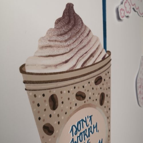 A white background with a latte coloured coffee frappe in a plastic cup with a teal coloured straw, which has the phrase "Don't Worry Be Frappe-y" on the front. There are little brown and white spots and coffee beans on the frappe, and there's also whipped cream on it to. Available in A5, A4 or A3 - pictured is the A4 size. The print is printed onto 230gsm Matte Photo Paper, with Recycled Cardboard + Compostable See-through bags to keep them safe.